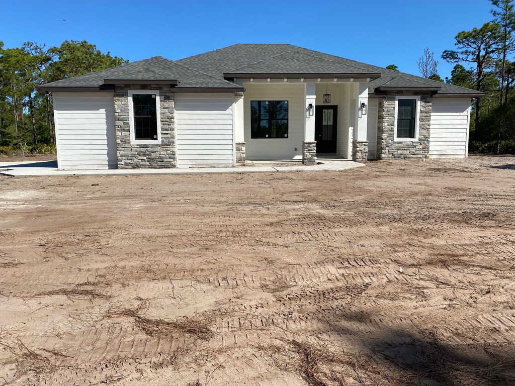 Modern Ranch-Style Home Under Construction: Stucco and Cultured Stone Elegance