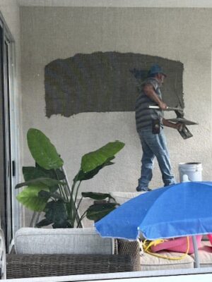 stucco repair on rear porch where existing window removed.