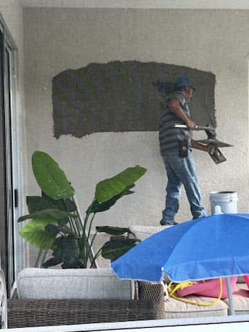 stucco repair on rear porch where existing window removed.