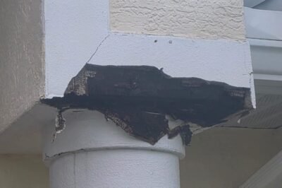 Damaged stucco around exterior column before repair