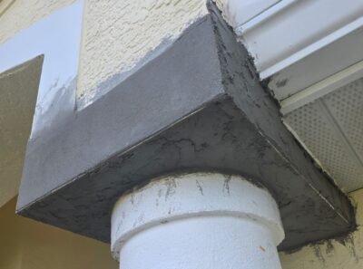 New cement coat applied around exterior column during Florida stucco repair